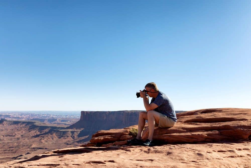 mature man taking photos of the grand canyon while sitting down apache junction rv parks